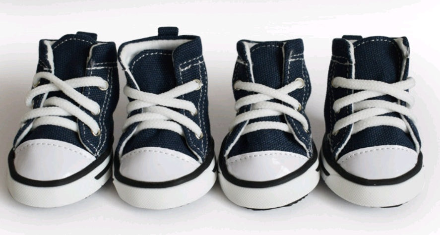Four pairs of navy blue and white high-top sneakers on a white background. Bishop X 