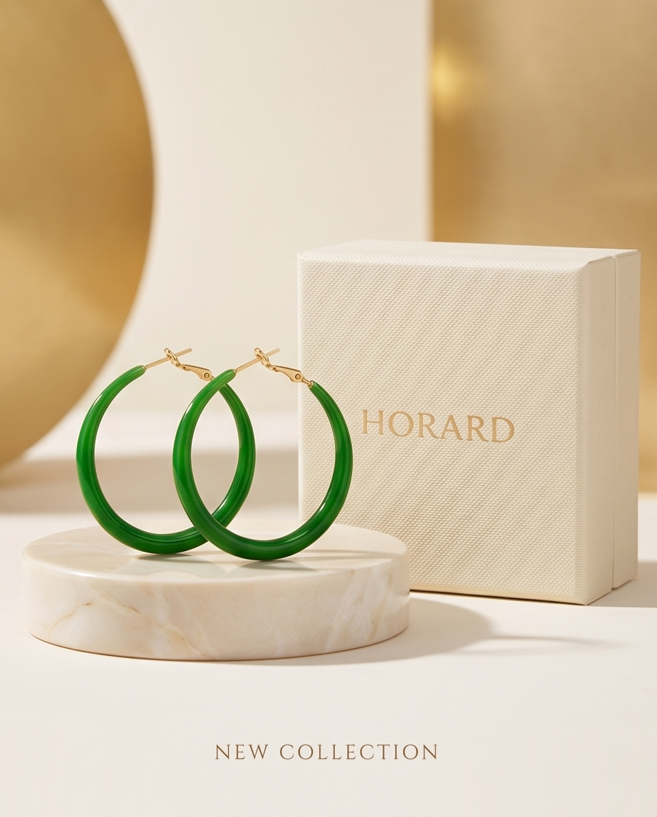 Green hoop earrings on a marble stand with a Horard box in the background.  BISHOP X 