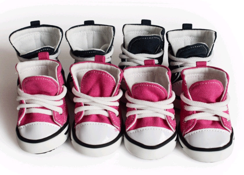 Set of baby shoes with pink and white design on a white background. Bishop X 