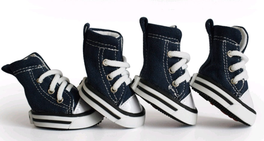 Pair of navy blue high-top sneakers with white laces on a white background. Bishop X 