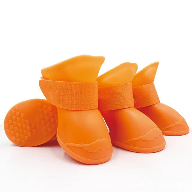 Orange dog boots with textured soles on a white background. Bishop x