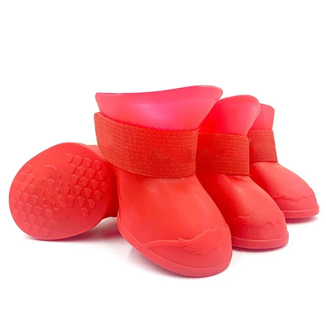 Set of red dog boots with textured soles on a white background . Bishop x