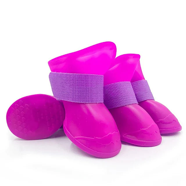 Purple rain boots with purple straps on a white background.  Bishop x 