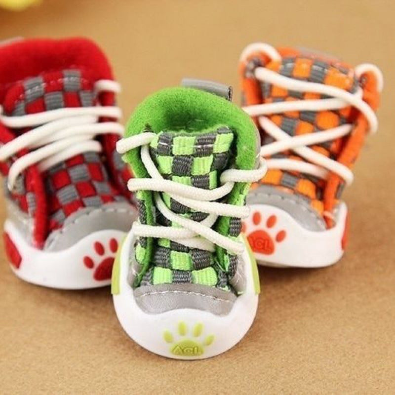 Colorful pet shoes with paw designs on a brown background. Bishop X