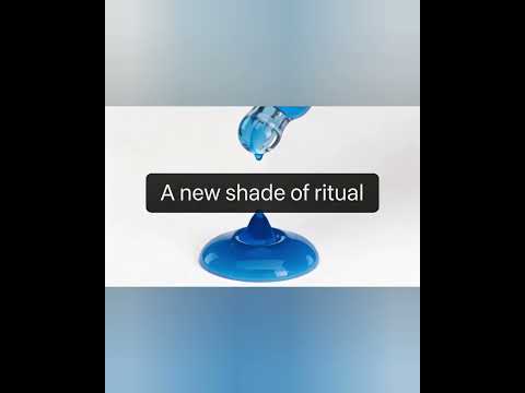 Close‑up of a dropper dispensing a bright blue Methylene Blue drop, captured mid‑air as it falls onto a glossy surface with the phrase A new shade of ritual. Bishop Elite Supplements 