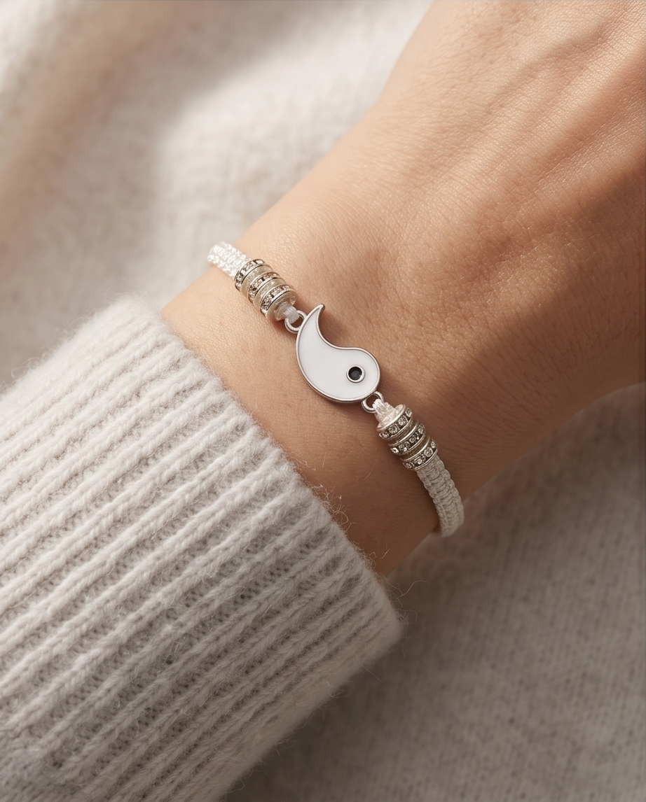 Silver bracelet with a unique charm on a wrist against a neutral background.  Bishop x 