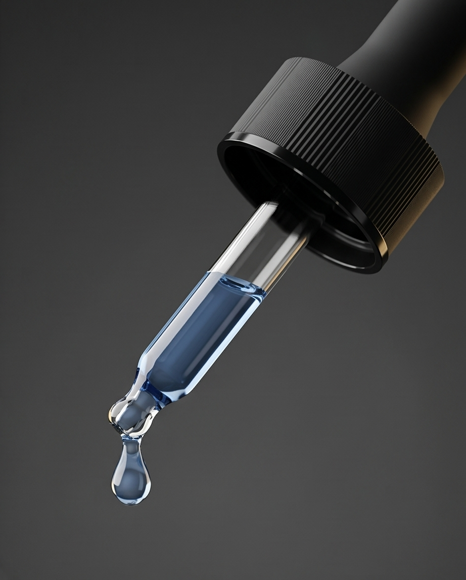 Black dropper with blue liquid on a dark gray background.  Bishop Elite Supplements 