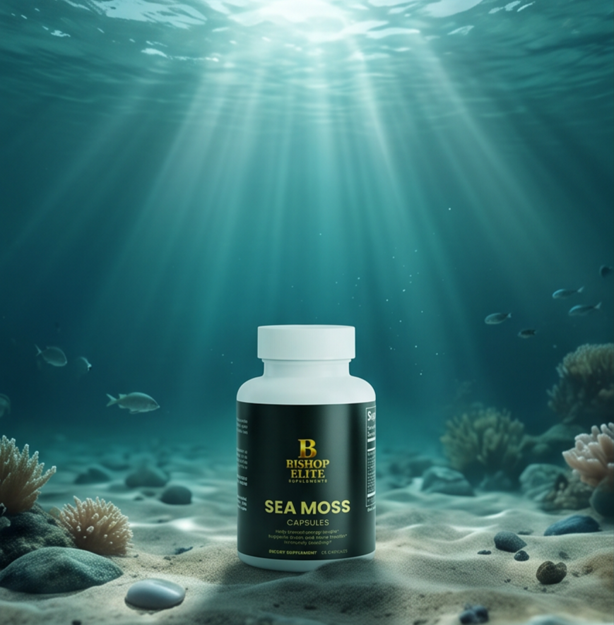 A white bottle of Bishop Elite Sea Moss Capsules stands on sandy ocean floor under bright sunbeams filtering through the water, with coral and fish in the background. Bishop Elite Supplements 