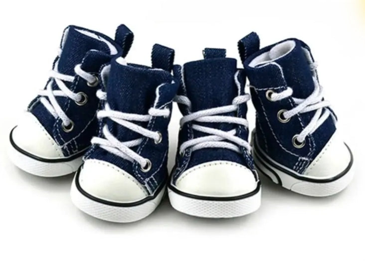 Set of four navy blue high-top sneakers with white laces on a white background.  Bishop x