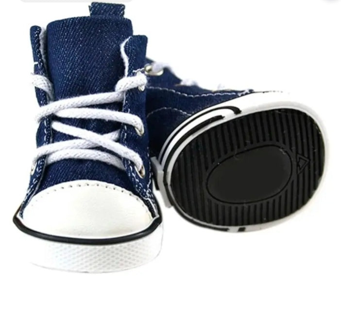 Pair of blue high-top sneakers with white laces on a white background. Bishop x