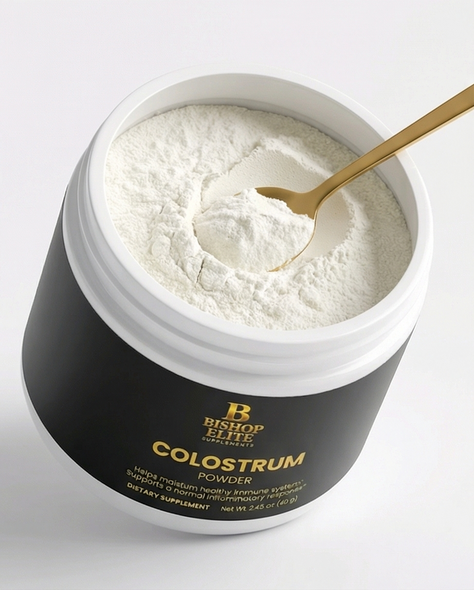 Jar of colostrum powder with a gold spoon on a light gray background.  Bishop Elite Supplements 