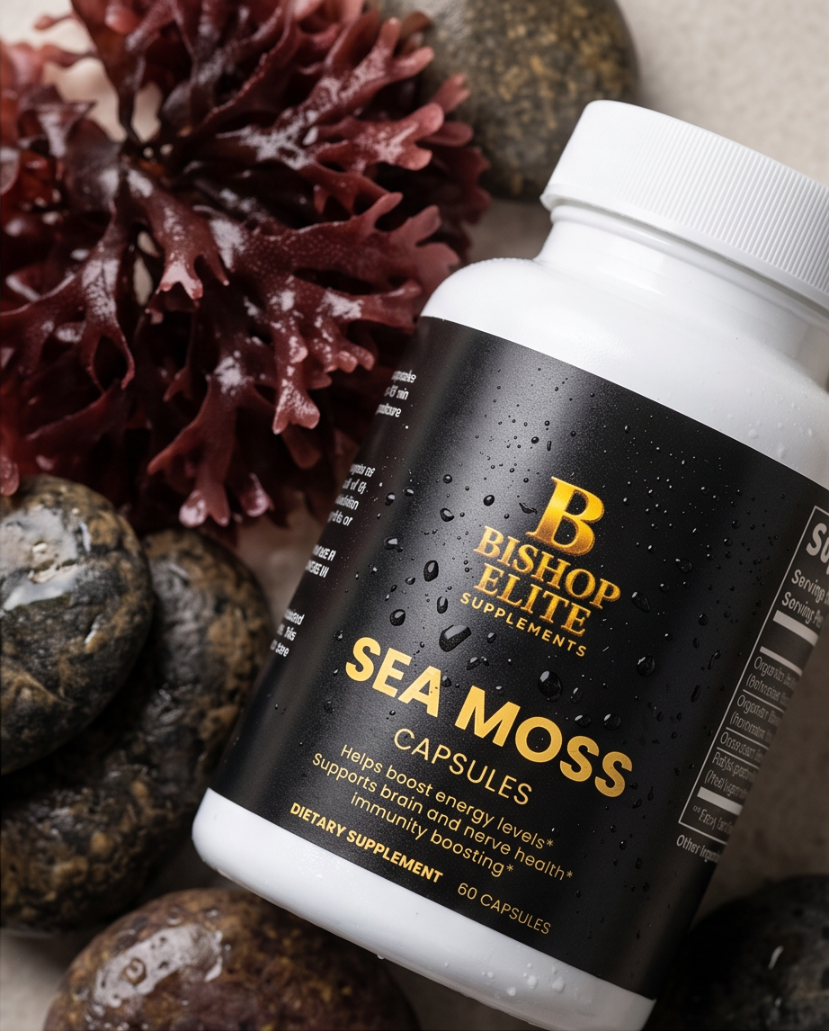 A white bottle of Bishop Elite Supplements Sea Moss Capsules with a black label, styled with wet rocks and red seaweed in the background. Bishop Elite Supplements 
